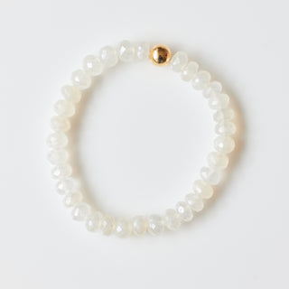 Pearl bracelet with a gold bead on a white background