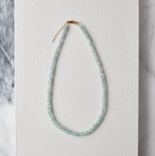 aquamarine Necklace on a white card with a marble background