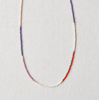 Necklace on a white card with a marble background