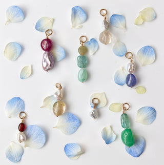 Set of colorful charms on a white card with a marble background