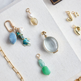 Jewelry with various pendants and chains on a white surface