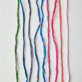 Colorful yarn strands on a white background