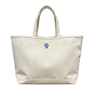 Beige tote bag with a small logo on a white background