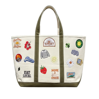 Tote bag with various stickers on a white background