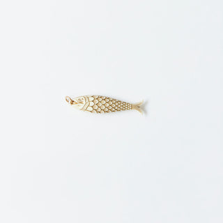 ivory and Gold fish-shaped pendant on a white background