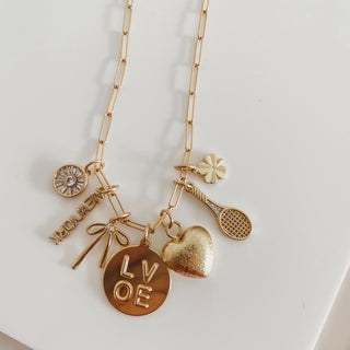 charm necklace with seven charms on white background 