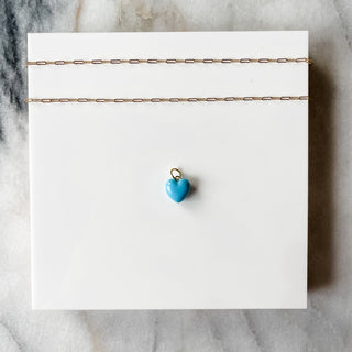 blue puff heart charm on white background