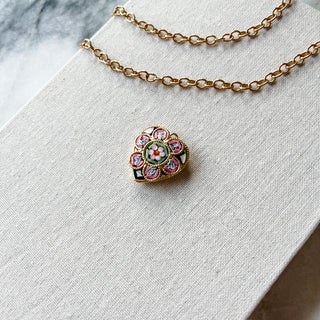 Necklace with a heart-shaped pendant on a white surface