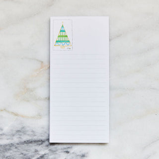 Notepad with a Christmas tree design on a marble surface