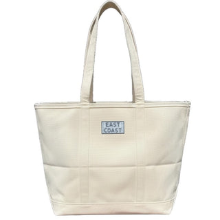 Beige tote bag with 'East Coast' label on a white background