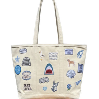 Beige tote bag with various appliqué designs on a white background