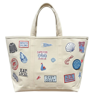 Beige tote bag with various graphics and text on a white background