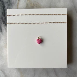 light pink puff heart charm on white background