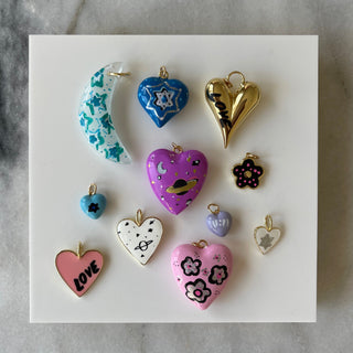 Collection of colorful heart-shaped charms on a marble background