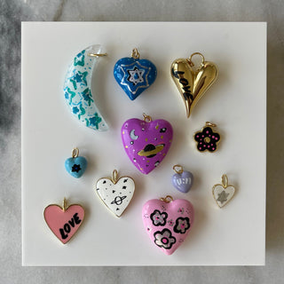 Collection of colorful heart-shaped charms on a marble background